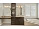 Bathroom with tub, large vanity, and plentiful windows at 14841 W Warren Ave, Lakewood, CO 80228