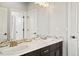 A modern bathroom with a double sink vanity and a large mirror at 14841 W Warren Ave, Lakewood, CO 80228