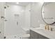 A renovated bathroom featuring herringbone tile in the shower and a modern vanity at 14841 W Warren Ave, Lakewood, CO 80228