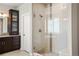 Modern bathroom with glass shower and updated vanity with plenty of storage space at 14841 W Warren Ave, Lakewood, CO 80228