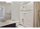 Bathroom with a modern sink and vanity, mosaic backsplash, and a shower over the tub at 14841 W Warren Ave, Lakewood, CO 80228