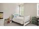 bedroom with a white frame bed, white walls and plenty of natural light at 14841 W Warren Ave, Lakewood, CO 80228