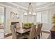 Elegant dining room with modern chandelier and neutral tones creates a stylish setting for meals and gatherings at 14841 W Warren Ave, Lakewood, CO 80228