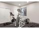 Bright exercise room featuring modern equipment, mirrored closet doors, and neutral color palette at 14841 W Warren Ave, Lakewood, CO 80228