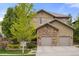 This lovely home features stone accents and a two-car garage, blending elegance with practical design at 14841 W Warren Ave, Lakewood, CO 80228