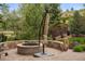 Beautiful outdoor fire pit area with stone surround, perfect for entertaining and relaxation at 14841 W Warren Ave, Lakewood, CO 80228
