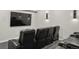 A home theater with black leather recliners and sconce lighting at 14841 W Warren Ave, Lakewood, CO 80228
