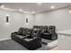 A home theater with tiered seating, black leather recliners and sconce lighting at 14841 W Warren Ave, Lakewood, CO 80228