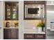 Modern kitchen with stainless steel appliances, dark cabinetry, and light countertops at 14841 W Warren Ave, Lakewood, CO 80228