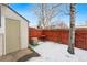 Small backyard with shed, wooden fence, and a light dusting of snow at 4626 S Dillon Ct # B, Aurora, CO 80015