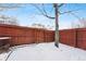Small backyard with a wooden fence and snow covered ground at 4626 S Dillon Ct # B, Aurora, CO 80015