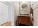 Small bathroom with granite vanity and oval framed mirror at 4626 S Dillon Ct # B, Aurora, CO 80015