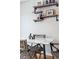 Small dining area with marble table, woven chairs, and industrial-style shelving at 4626 S Dillon Ct # B, Aurora, CO 80015