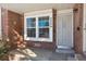 Front entry with brick facade and security door at 4626 S Dillon Ct # B, Aurora, CO 80015