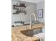 Modern kitchen sink and granite countertop with a sleek faucet at 4626 S Dillon Ct # B, Aurora, CO 80015