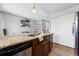 Kitchen boasts granite countertops and modern, dark wood cabinets at 4626 S Dillon Ct # B, Aurora, CO 80015