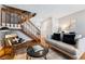 Open living room with hardwood floors, staircase, and comfortable seating at 4626 S Dillon Ct # B, Aurora, CO 80015