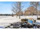 Snowy park with trees, a bench, and a sign that reads 'Sandbrush Park' at 4626 S Dillon Ct # B, Aurora, CO 80015