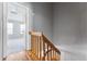 Upstairs hall with wood railing and view of bedroom at 4626 S Dillon Ct # B, Aurora, CO 80015