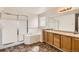 Bathroom featuring a separate shower, soaking tub, and dual sinks with wood cabinets at 20000 E Mitchell Pl # 34, Denver, CO 80249