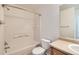 Bright bathroom features a shower-tub combo, tiled walls, and a vanity with sink at 20000 E Mitchell Pl # 34, Denver, CO 80249