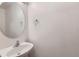 Powder room featuring a white sink, round mirror, and neutral walls at 20000 E Mitchell Pl # 34, Denver, CO 80249