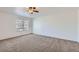 Spacious bedroom with neutral carpet, a ceiling fan, and a large window providing natural light at 20000 E Mitchell Pl # 34, Denver, CO 80249