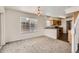 Open dining room with chandelier, next to the kitchen with wood cabinets and sleek countertops at 20000 E Mitchell Pl # 34, Denver, CO 80249