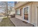 Front entrance with brick platform and glass storm door, leading into the residence at 20000 E Mitchell Pl # 34, Denver, CO 80249