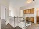 Upper-level hallway includes natural light and oak wood cabinets at 20000 E Mitchell Pl # 34, Denver, CO 80249