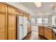 Open kitchen area boasts wood cabinets, stainless steel appliances, and access to the backyard at 20000 E Mitchell Pl # 34, Denver, CO 80249