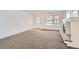 Bright living room with neutral carpet, fireplace, and large windows allowing natural light at 20000 E Mitchell Pl # 34, Denver, CO 80249