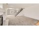 Spacious living room featuring a fireplace, staircase, and neutral carpeting for a modern look at 20000 E Mitchell Pl # 34, Denver, CO 80249