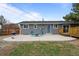 Spacious backyard with concrete patio, barbecue, fire pit, and wood deck at 7906 S Dover St, Littleton, CO 80128