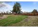 Large grassy backyard with wooden fence, patio, and deck perfect for entertaining at 7906 S Dover St, Littleton, CO 80128