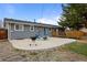 Spacious backyard with concrete patio, barbecue, fire pit, and wood deck at 7906 S Dover St, Littleton, CO 80128