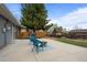 A view of the backyard with a patio and a seating area with blue chairs at 7906 S Dover St, Littleton, CO 80128