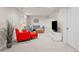 Finished basement featuring an orange chair, gray sectional sofa, and a flatscreen TV at 7906 S Dover St, Littleton, CO 80128