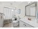 Clean, well-lit bathroom with white fixtures, including vanity, toilet, and shower with curtain at 7906 S Dover St, Littleton, CO 80128