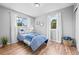 Comfortable bedroom featuring hardwood floors, neutral walls, and two windows with natural light at 7906 S Dover St, Littleton, CO 80128
