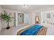 Finished basement bedroom with open doors, neutral colored carpet and a green plant at 7906 S Dover St, Littleton, CO 80128