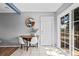 Cozy dining area showcasing a round wooden table, two white chairs, and a view of the backyard at 7906 S Dover St, Littleton, CO 80128