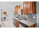 Well-lit kitchen with stainless steel appliances, grey countertops, light backsplash, and wooden cabinets at 7906 S Dover St, Littleton, CO 80128