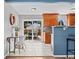 Bright eat-in kitchen featuring stainless steel appliances, wood cabinetry, and sliding door to outdoor patio at 7906 S Dover St, Littleton, CO 80128
