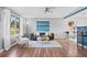 Bright and spacious living room with hardwood floors, large window, and comfortable seating for relaxation at 7906 S Dover St, Littleton, CO 80128