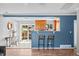 Open-concept living room with hardwood floors, breakfast bar, and a view to the dining area and kitchen at 7906 S Dover St, Littleton, CO 80128
