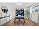 Bright home office featuring hardwood floors, a modern desk, and ample shelving for organization and decor at 7906 S Dover St, Littleton, CO 80128