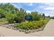 The entrance to Coronado Park has a lush green landscape, trees, and a sign for the park at 7906 S Dover St, Littleton, CO 80128