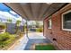 Lovely outdoor living space with a retractable shade and brick detail at 6005 W 39Th Ave # 6005, Wheat Ridge, CO 80033