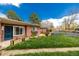 Beautiful brick home featuring a well-maintained lawn and vibrant landscaping at 6005 W 39Th Ave # 6005, Wheat Ridge, CO 80033
